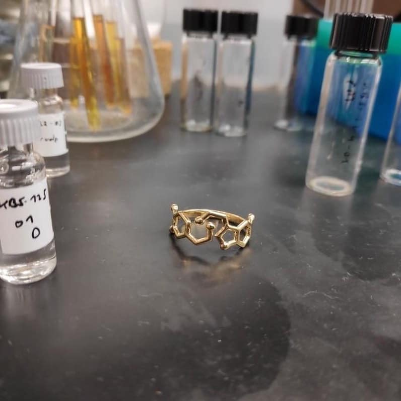 A ring with the molecules dopamine and serotonin in a chemistry laboratory.