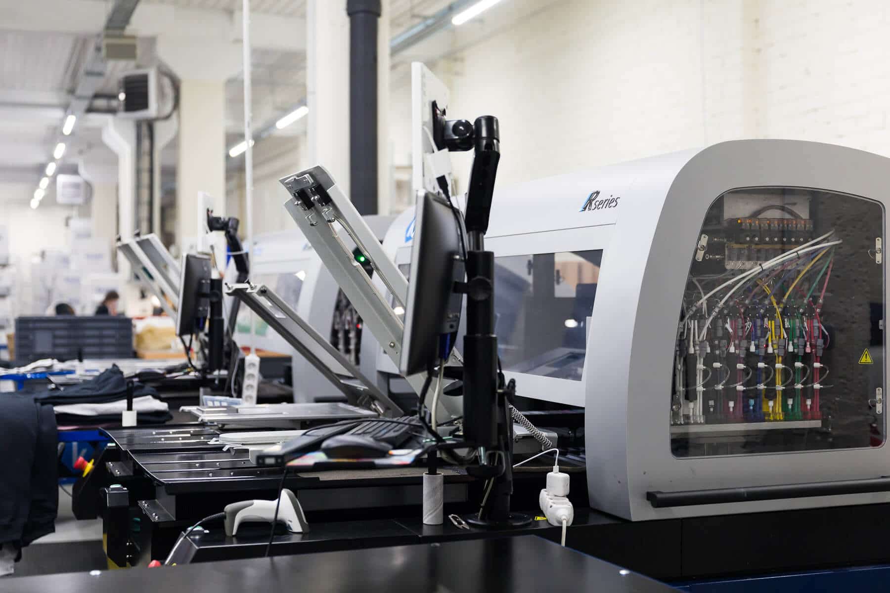 A DTG printer printing science jokes t-shirts.